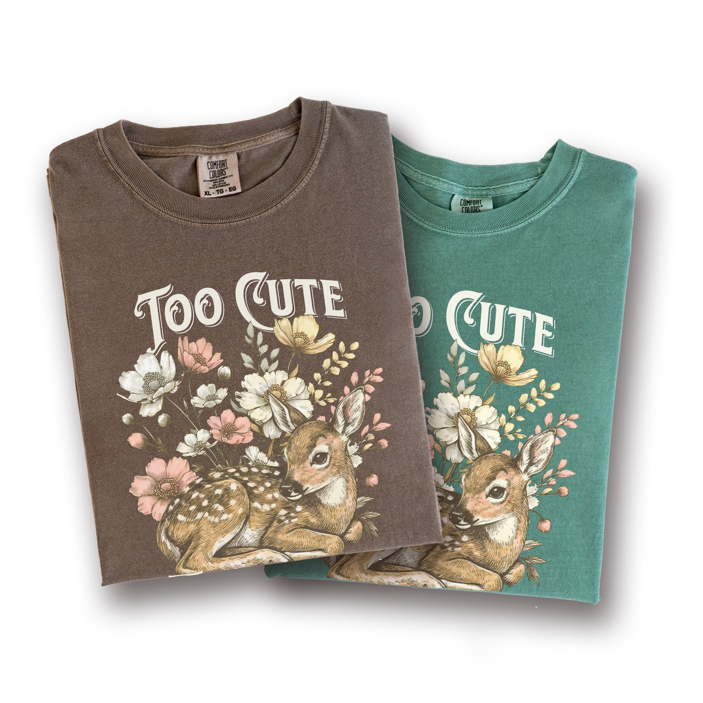 Two folded t-shirts with a deer and floral design and 'Too Cute' text on a white background.