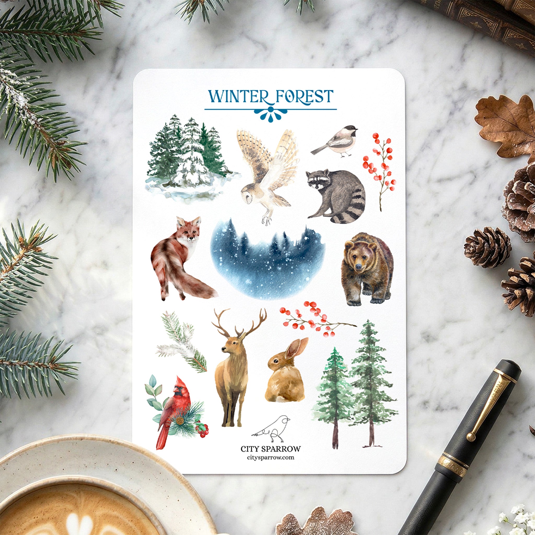 Sticker sheet titled 'Winter Forest' with various animals and nature elements on a marble surface.