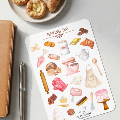 Sheet of 'Baking Day' themed stickers with illustrations on a gray surface with pastries and a pen.