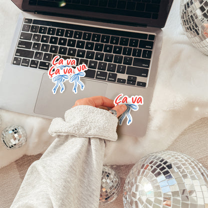Laptop on a fluffy surface with disco balls and a hand wearing a textured sleeve.