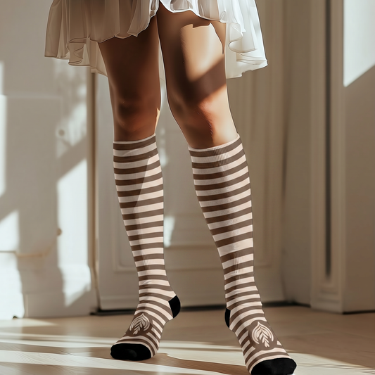 Person wearing striped knee-high socks in a room with sunlight filtering through.