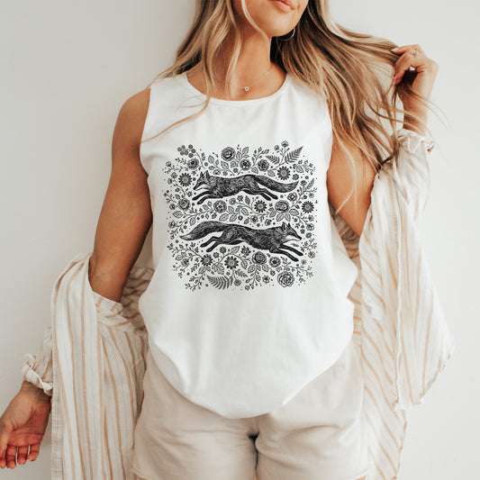 Woman wearing a white tank top with black floral and fox design.