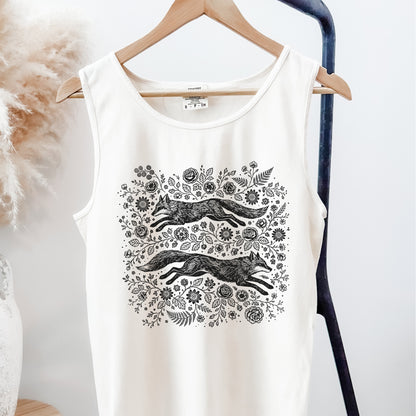 White tank top with black fox and floral design on a hanger against a white background
