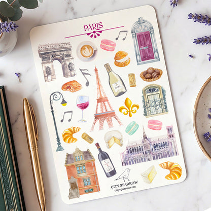 Sheet of Paris-themed stickers with Eiffel Tower and other city elements on a marble surface.