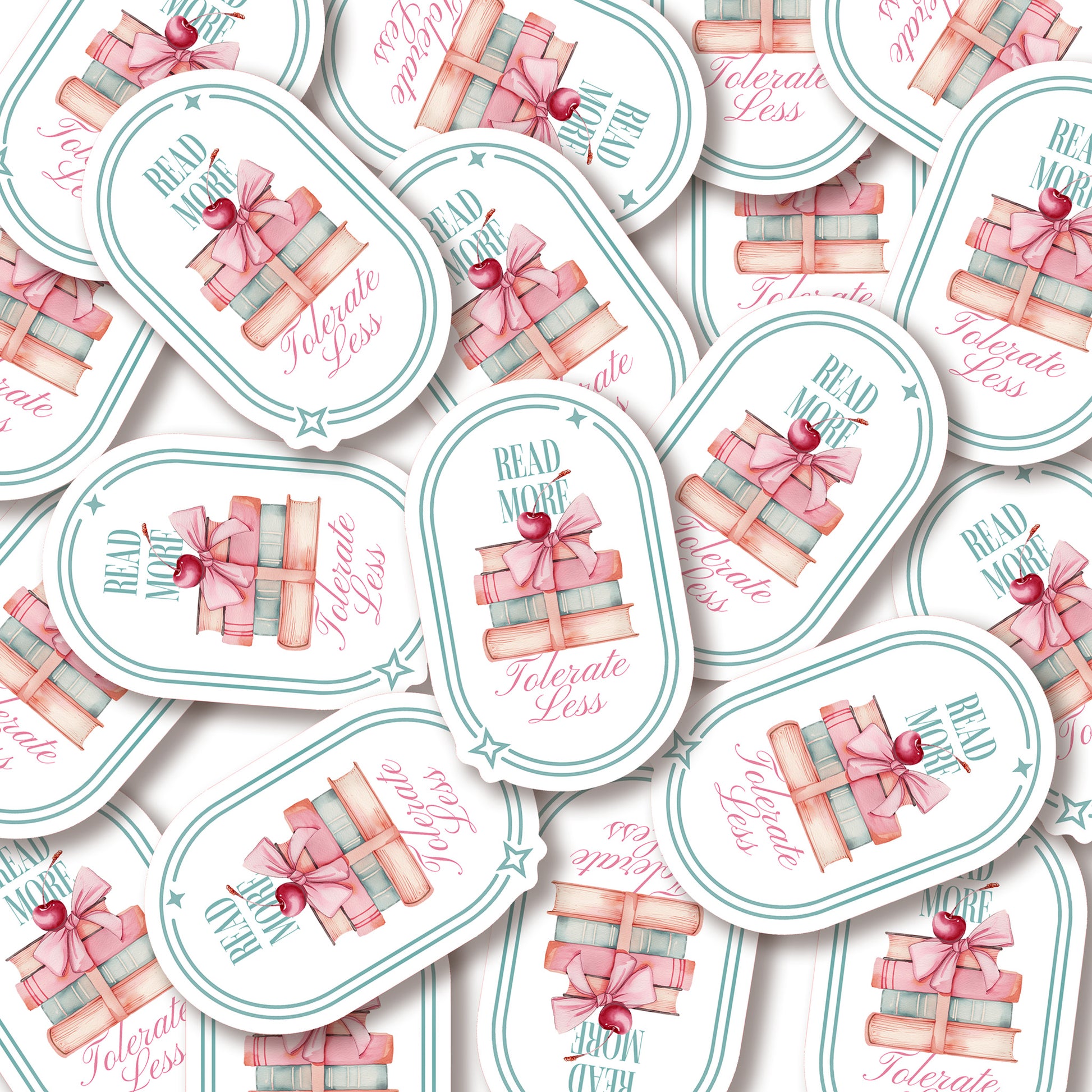 A pile of stickers with book-themed design and text that says Read More Tolerate Less  with a stack of books tied with a bow