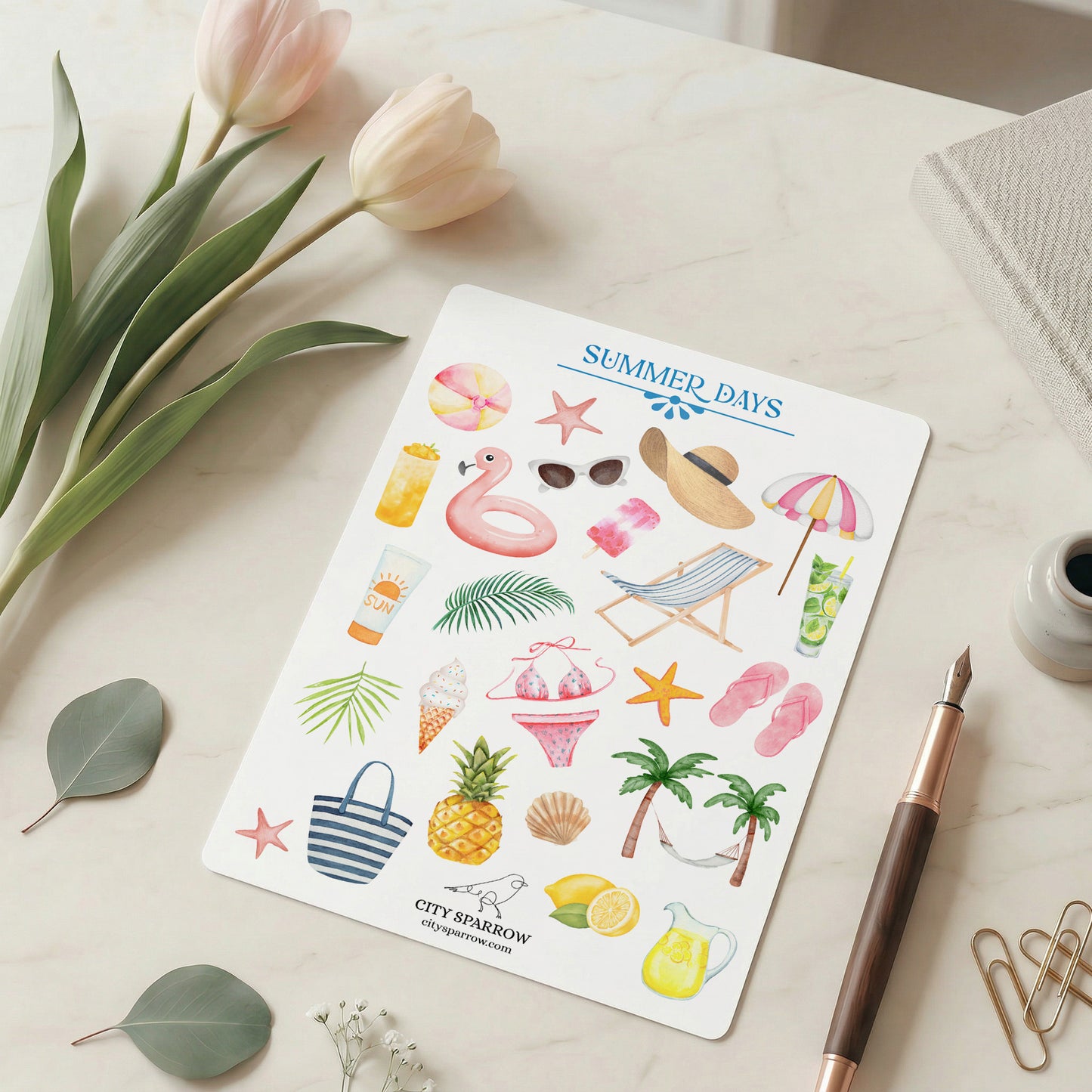 Sheet of summer-themed stickers with a pen and tulips on a light surface