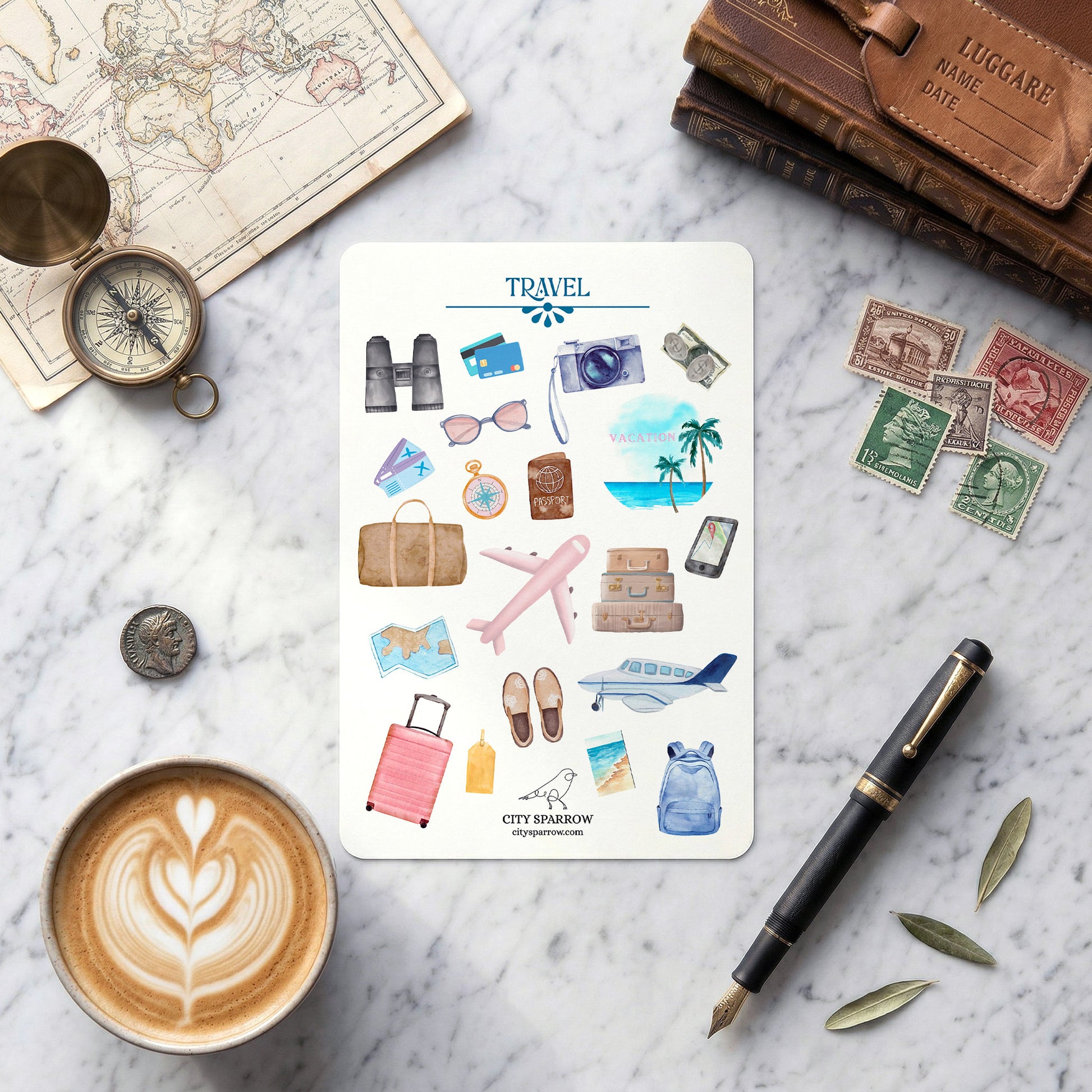 Travel-themed sticker sheet on a marble surface with coffee, pen, and decorative items.