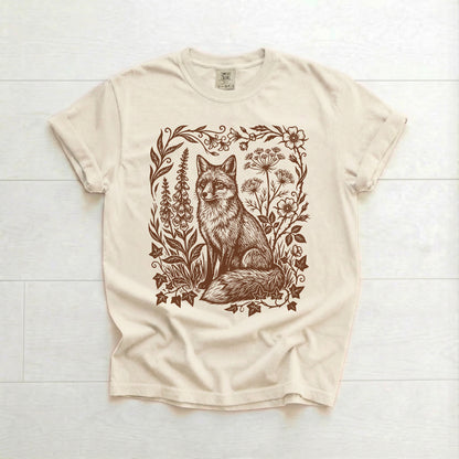 Beige t-shirt with a fox and floral design on a white wooden background