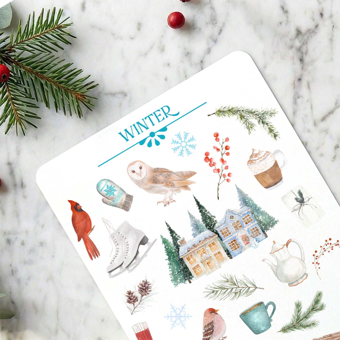 Sheet of winter-themed stickers with illustrations on a marble surface.